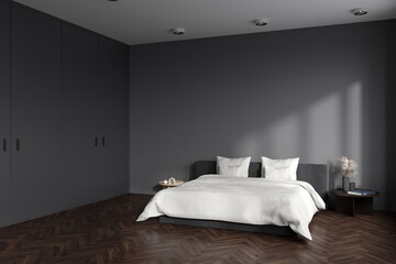 Corner view on dark bedroom interior with empty grey wall