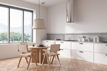 Fototapeta na wymiar Light kitchen interior with eating table and kitchenware, panoramic window