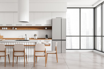 Kitchen interior with countertop and chairs, kitchenware and panoramic window