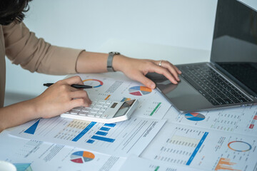 Marketing, Financial, Accounting, Planning, Team of female businessmen and economists use calculators and computers and graph documents to profit the company.