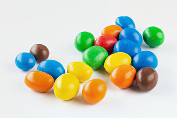 Chocolate coated Peanuts. Colorful chocolate buttons, on white background.
