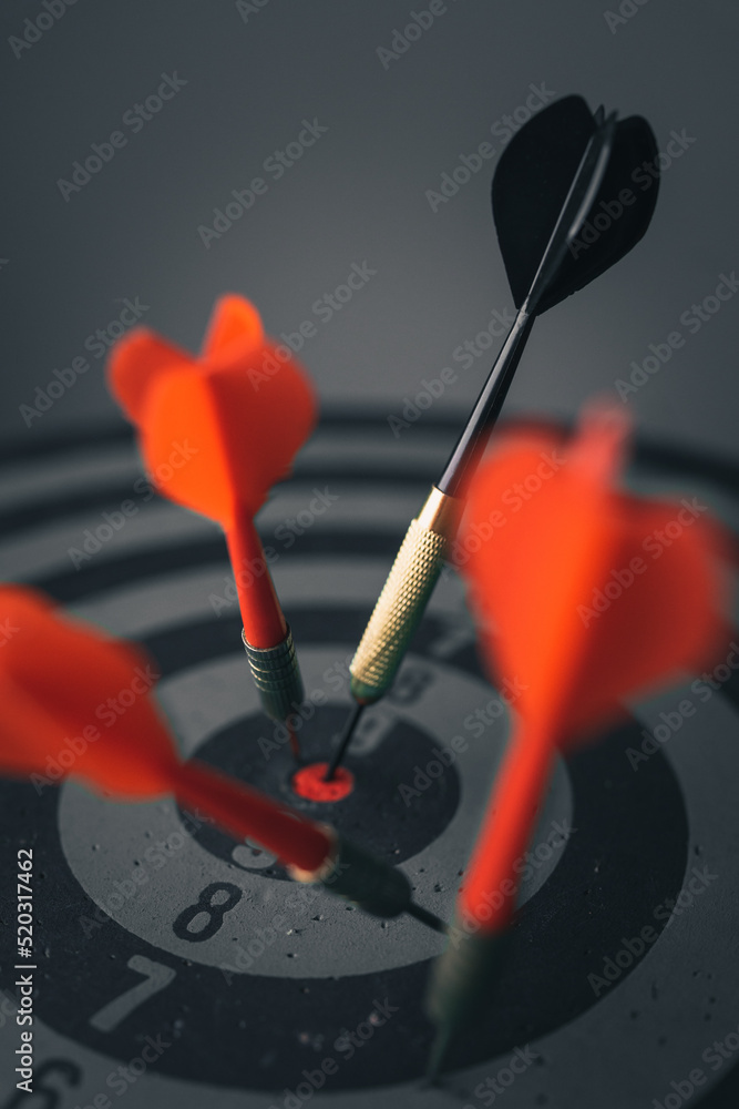Poster close up shot of the dart arrow hit on bulleyes of dartboard to represent that the business reached 