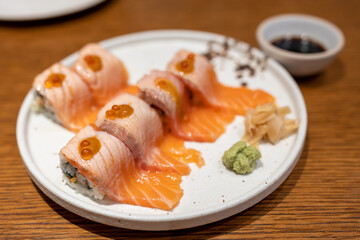 Tasty appetizing classic italian spaghetti pasta with creamy sauce, cheese parmesan and basil on plate on dark table at cafe restuarant.	
