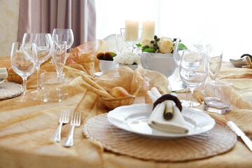 Detail of a table set in ocher color organza for a wedding banquet