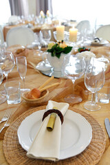 Detail of a table set in ocher color organza for a wedding banquet