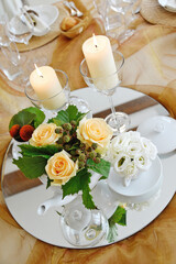 Detail of a table set in ocher color organza for a wedding banquet