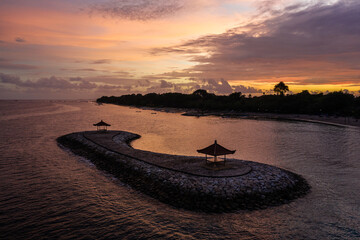 Fototapeta na wymiar Sanur, Indonesia: Dramatic sunset over the Sanur beach in Bali, famous for its padoga.
