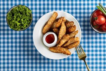 Delicious crispy fried breaded chicken breast strips .