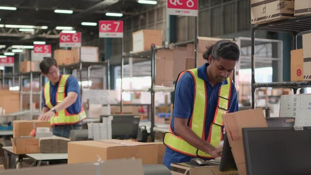 Two asian warehouse worker working checking package products in warehouse, logistic..While staff used laser barcode scanner on cardboard box, distribution center, placement in storage for shipping.