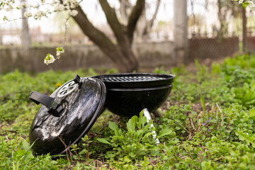 Empty Barbecue Grill Close-up In The Backyard Lawn At Summer.