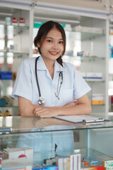 Medicine and health concept, Female pharmacist stand with crossed arms in front of medicine shelves