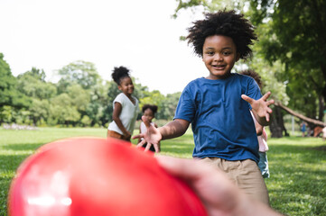 African American kids play frisbee in the park
