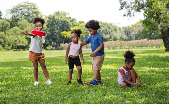 African American kids play frisbee in the park