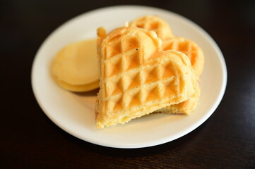 waffle and pancake on white plate.