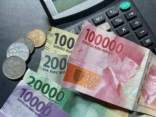 Indonesian money and calculator, financial concept photo.