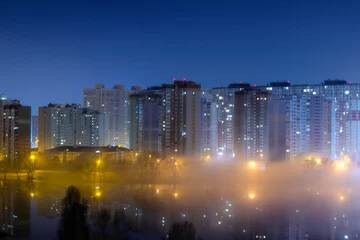 Foto op Aluminium Night cityscape of the big city. Awesome bright, multi colored light in thick fog at empty streets. Apartment buildings in bedroom community, commuter town area. Darnytsia, Kyiv. Ukraine. 2021 © Sodel Vladyslav