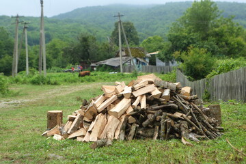 Woodpile near a wooden fence