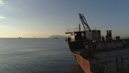 Aerial view of the ship washed ashore. Shot. Top view of an abandoned old and rusty shipwreck on a...