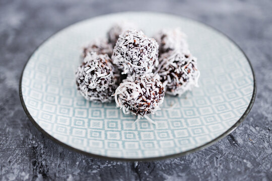 Healthy Plant-based Food, Vegan Chocolate And Nut Butter Bliss Balls With Coconut Topping