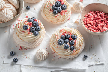 Homemade and tasty Pavlova dessert with whipped cream and fruit.