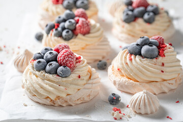 Homemade and tasty Pavlova dessert with fruits and white meringue.