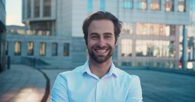 Businessman smiling on roof. Stylish fashion groom on the outside.