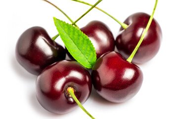 Sweet cherries with cherry leaf isolated on a white background.