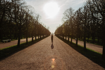 a girl in the park posing against the sunset