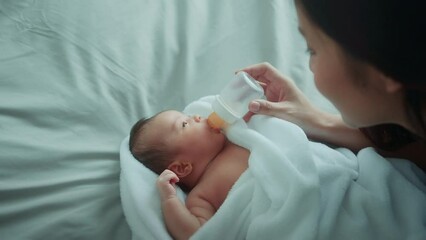 Portrait of Cute new born baby drinking milk bottle.