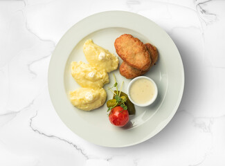Potato with a cutlet on a white background, food photography.