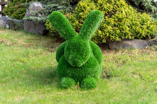 the figure of a rabbit made of artificial grass. garden decoration
