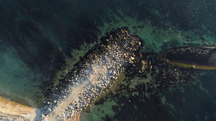 Aerial view of the ship washed ashore. Shot. Top view of an abandoned old and rusty shipwreck on a...