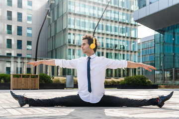Flexible and cool businessman doing acrobatic trick