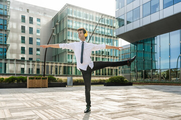 Flexible and cool businessman doing acrobatic trick