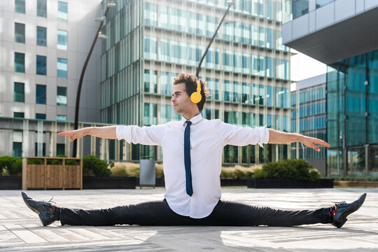 Flexible and cool businessman doing acrobatic trick - Powered by Adobe