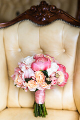 Colorful wedding bouquet on a vintage chair