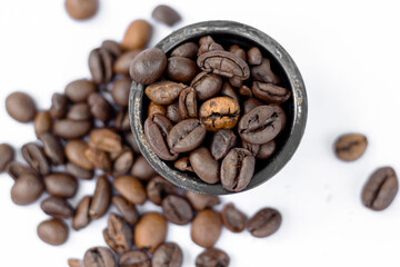 coffee beans vs  in capsules,pods.roasted brown coffee beans in heart shape for cookies and opened coffee pod.isolated on white or light background.sunshine,sun shadows.fresh  beans in capsule