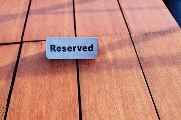 The table in the restaurant put reservation sign for the customer, the reservation sign written...