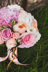 Colorful wedding bouquet on the grass near the tree
