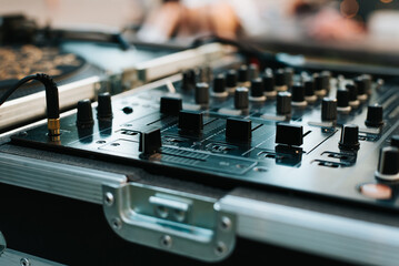 DJ set mixing console close-up outdoors. Selective soft focus