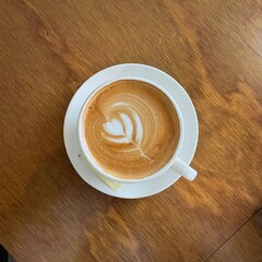 latte art cup of cappuccino and Café Latte on wood tab