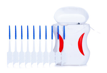 Interdental tooth brushes and dental floss on white background isolation