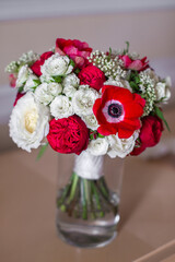 Wedding bouquet stands in a vase with water