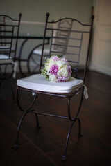 Colorful wedding bouquet on a vintage chair