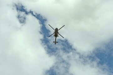 Fototapeta na wymiar A helicopter is flying low overhead