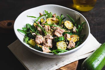fresh salad with arugula, baked zucchini and tuna. the concept of healthy and nutritious food