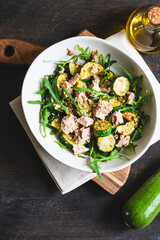 fresh salad with arugula, baked zucchini and tuna. the concept of healthy and nutritious food