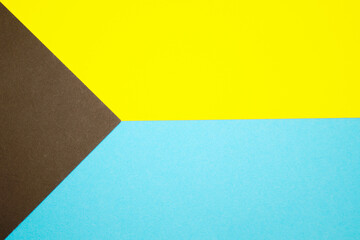 Graphic background of different geometric shapes in three colors: blue, yellow, black.