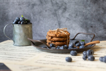 Homemade oatmeal cookies on a metal plate against the background of an old table. Healthy food concept. copy space.