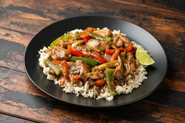 Stir fry pepper chicken with sweet peppers, onion, garlic and ginger